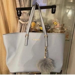 Baby blue Michael Kors tote bag small stain.